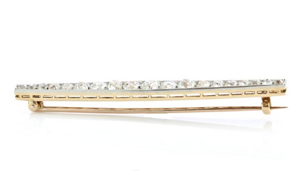 Art Deco Old Cut Diamond Bar Brooch; set with 1.20 carats of graduating old-cut diamonds. Mounted in platinum and backed with 18ct yellow gold. Circa 1920s