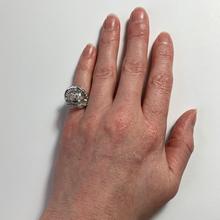 Retro Diamond and Platinum Cocktail Ring; designed as a dome with curved and flaring ridges, set with 2.55 carats round brilliant cut and baguette diamonds