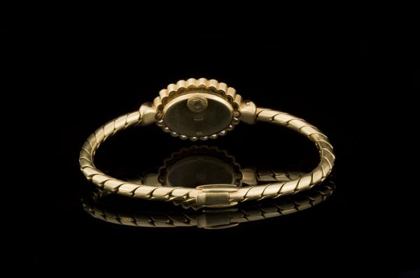 Vintage Vacheron Constantin 18ct Yellow Gold Watch with Diamonds and Emeralds; solid 18ct gold ladies manual wristwatch with diamond bezel accented with emerald set terminals. Made in Switzerland, Circa 1950s