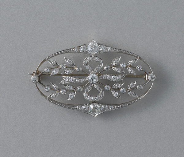 Antique Edwardian Diamond Oval Floral Bow Brooch; set with 67 old cut diamonds, 1.50 carat total, openwork bow and delicate design. Set in platinum and backed with yellow gold. Dutch, Circa 1910