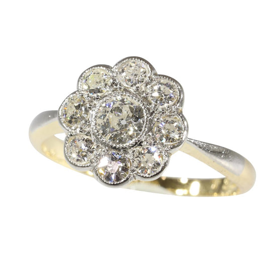 This vintage 1920's Art Deco diamond cluster engagement ring is set in platinum and 18 carat yellow gold. 