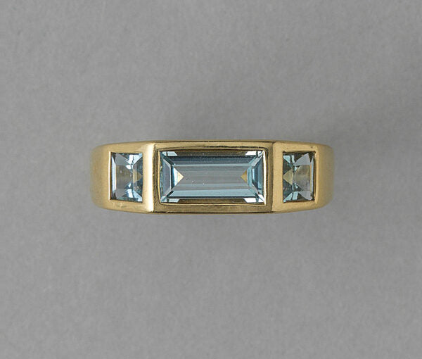 Tiffany and Co Aquamarine and 18ct Gold Ring by Paloma Picasso; central 1.30ct baguette cut aquamarine flanked by square cut aquamarines, Signed