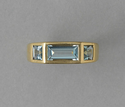 Tiffany and Co Aquamarine and 18ct Gold Ring by Paloma Picasso; central 1.30ct baguette cut aquamarine flanked by square cut aquamarines, Signed