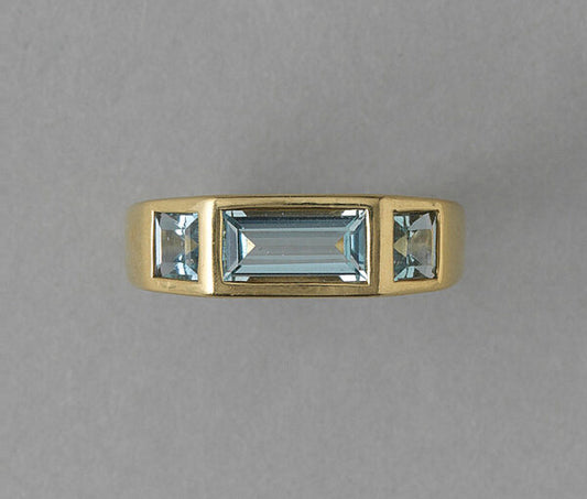 Tiffany and Co Aquamarine and 18ct Gold Ring by Paloma Picasso; central 1.30ct baguette cut aquamarine flanked by square cut aquamarines, Signed
