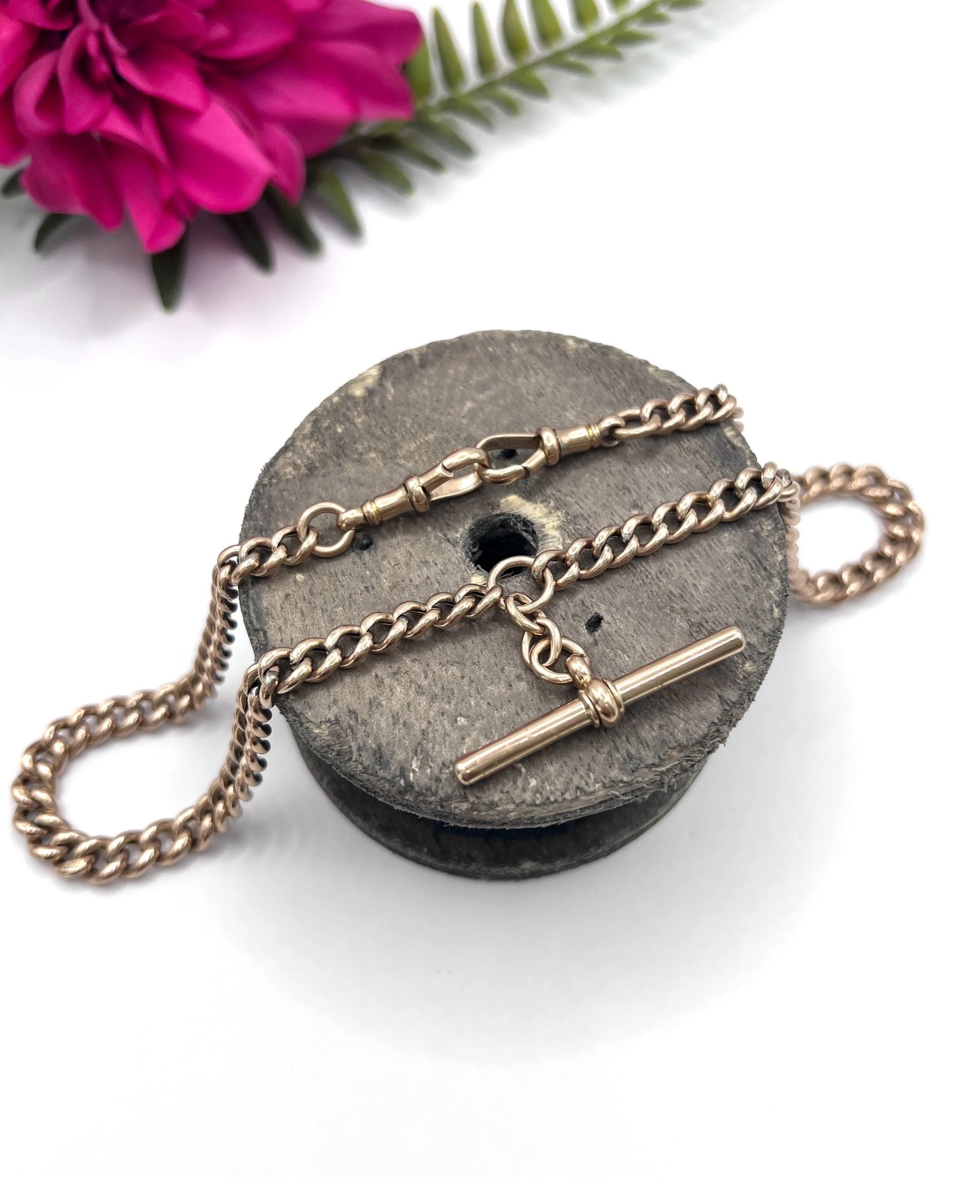 A rose gold curb link Albert chain with t-bar