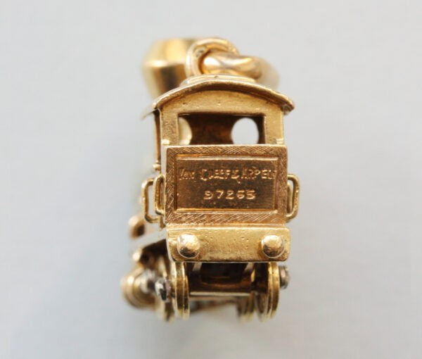 Vintage Van Cleef and Arpels 18ct Gold Locomotive Train Charm; with diamond and emerald set headlights, Signed and numbered 97265, with Van Cleef & Arpels 18ct gold chain bracelet.