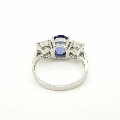 Madagascan Sapphire and Diamond Three Stone Trilogy Ring; central 2.52ct oval faceted Madagascan sapphire flanked by 2.00cts circular cut diamonds