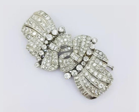 Vintage Diamond Double Clip Bow Brooch; set with baguette and brilliant-cut diamonds, in 18ct white gold. Total diamond weight: approximately 10.00 carats.