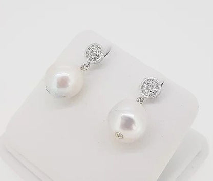 South Sea Pearl and Diamond Drop Earrings; featuring South Sea pearls suspended from a diamond set cluster stud, 0.28 carats, 18ct white gold