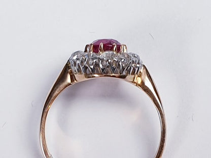 Antique Victorian Ruby and Diamond Oval Cluster Ring; featuring a 1.15 carat oval faceted ruby encompassed by 1.20cts sparkling diamonds, on a rose gold shank. English, Circa 1890