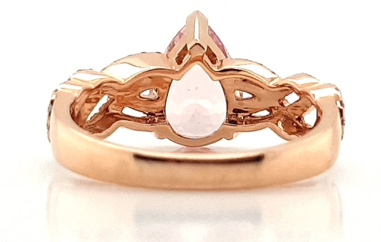 Pear Cut Morganite and Diamond Cluster Dress Ring; central 1.75 carat pear-shaped morganite flanked by 0.33cts diamond set overlapping waves and swirls, in 18ct rose gold