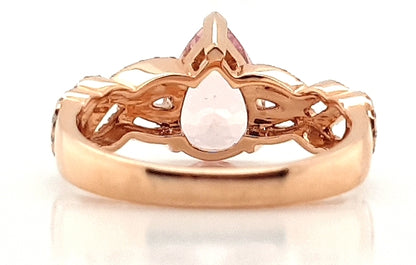 Pear Cut Morganite and Diamond Cluster Dress Ring; central 1.75 carat pear-shaped morganite flanked by 0.33cts diamond set overlapping waves and swirls, in 18ct rose gold