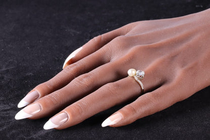 An Old Cut Diamond And Pearl Toi et Moi Ring In 18 Carat Yellow Gold And Platinum