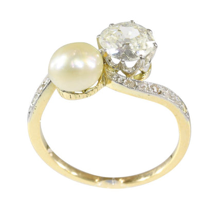 An Old Cut Diamond And Pearl Toi et Moi Ring In 18 Carat Yellow Gold And Platinum