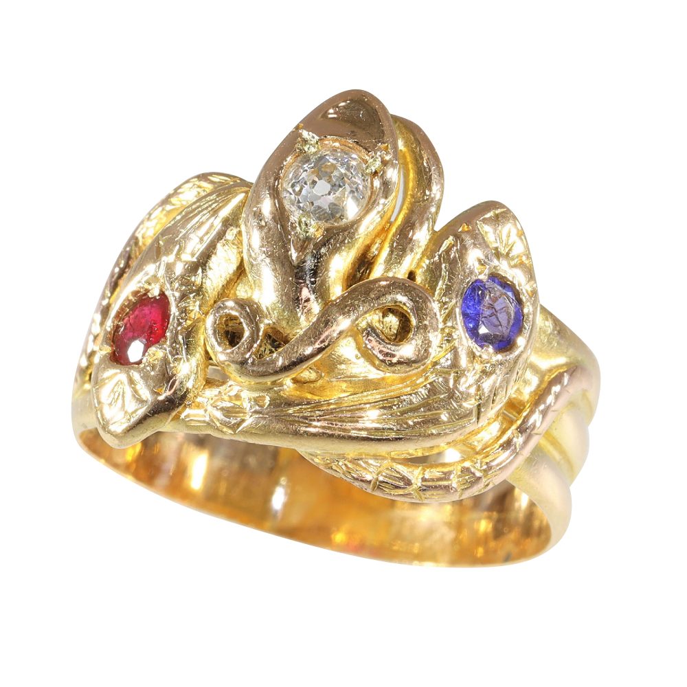 Victorian serpent ring in gold with three gemstones.