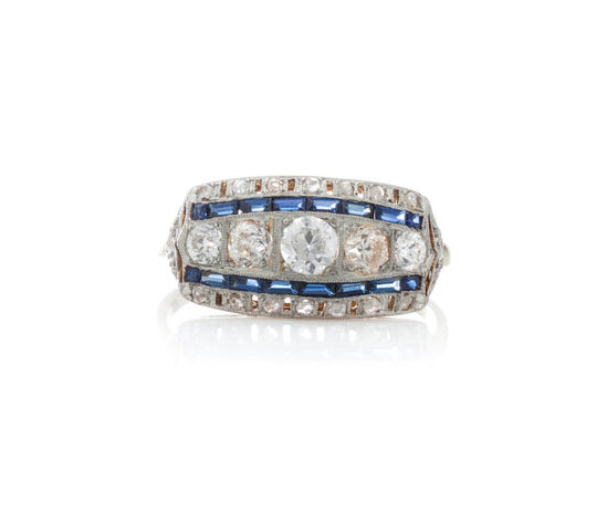Art Deco Old Cut Diamond and Sapphire Dress Ring; central band of graduating old-cut diamonds flanked by baguette cut sapphires and an outer border of old cut diamonds. Mounted in platinum on an 18ct yellow gold shank. Circa 1920s