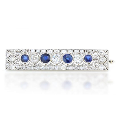 Art Deco Old Cut Diamond, Sapphire and Platinum Brooch, exquisite pierced platinum design encrusted with diamonds, encompassing the central row of alternating old cut diamonds and sapphires. Circa 1920s