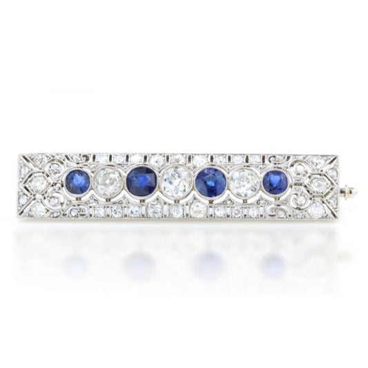 Art Deco Old Cut Diamond, Sapphire and Platinum Brooch, exquisite pierced platinum design encrusted with diamonds, encompassing the central row of alternating old cut diamonds and sapphires. Circa 1920s