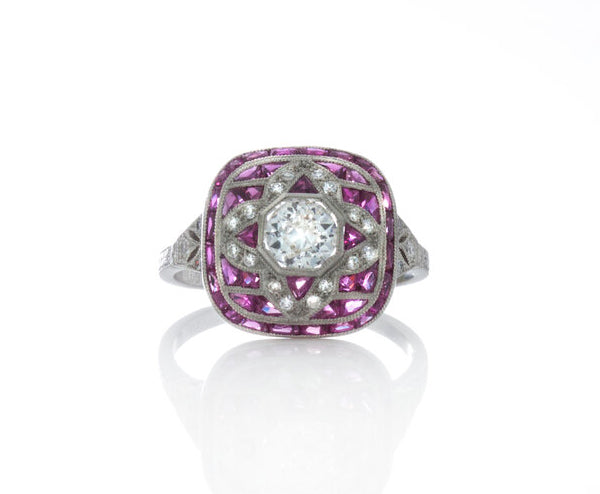 Cushion Shaped Diamond, Ruby and Platinum Cluster Dress Ring; set with diamonds and rubies, with a pierced under-gallery. Circa 1990's