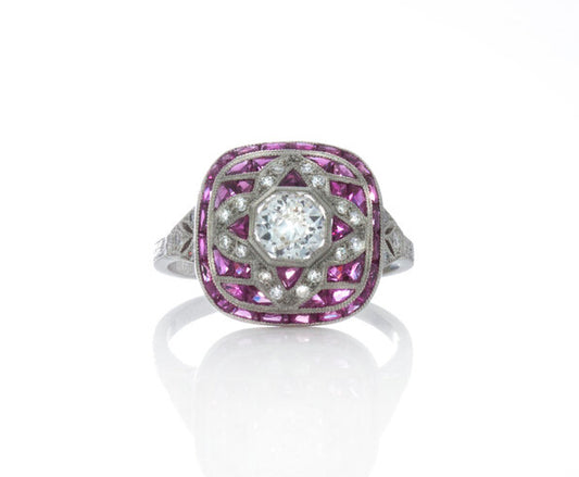 Cushion Shaped Diamond, Ruby and Platinum Cluster Dress Ring; set with diamonds and rubies, with a pierced under-gallery. Circa 1990's