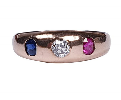 Antique Victorian Diamond, Sapphire and Ruby Three Stone Ring; central 0.33ct cushion cut diamond with 0.25ct ruby one side and 0.25ct sapphire the other side, in gold. English, Circa 1880