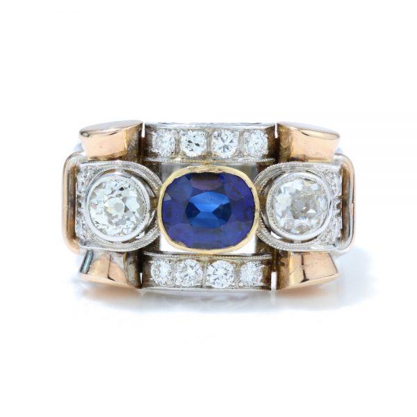 Vintage Sapphire and Old Cut Diamond Dress Ring; central sapphire and old cut diamond three stone ring section within a diamond-set geometric surround, in 18ct white and yellow gold