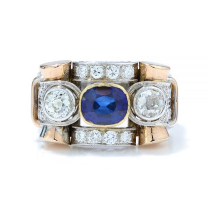 Vintage Sapphire and Old Cut Diamond Dress Ring; central sapphire and old cut diamond three stone ring section within a diamond-set geometric surround, in 18ct white and yellow gold