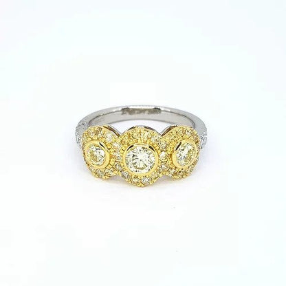Fancy Yellow Diamond Triple Cluster Ring; three fancy yellow diamonds surrounded by a border of yellow diamonds, set in yellow gold, mounted to a platinum shank with diamond set shoulders, 1.22 carats