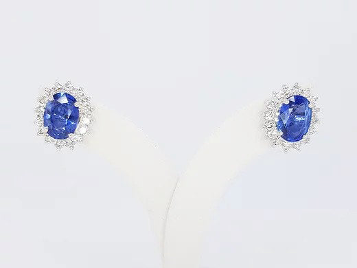 Sapphire and Diamond Oval Cluster Earrings; 2.46cts oval faceted sapphire surrounded by 0.78cts brilliant-cut diamonds, in 18ct white gold.