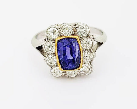 2.16ct Natural Sapphire and Diamond Cluster Ring; 2.16 carat cushion-shaped natural sapphire, surrounded by 0.98cts diamonds, in 18ct white and yellow gold