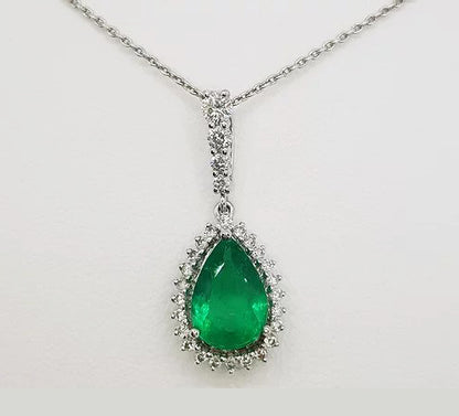 Emerald and Diamond Pear Shaped Cluster Pendant; 1.60ct pear-cut emerald surrounded by 0.59cts brilliant-cut diamonds, diamond set bale, in 18ct white gold.