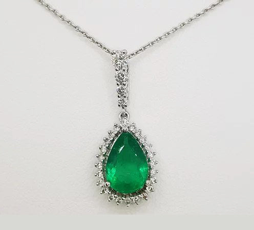 Emerald and Diamond Pear Shaped Cluster Pendant; 1.60ct pear-cut emerald surrounded by 0.59cts brilliant-cut diamonds, diamond set bale, in 18ct white gold.