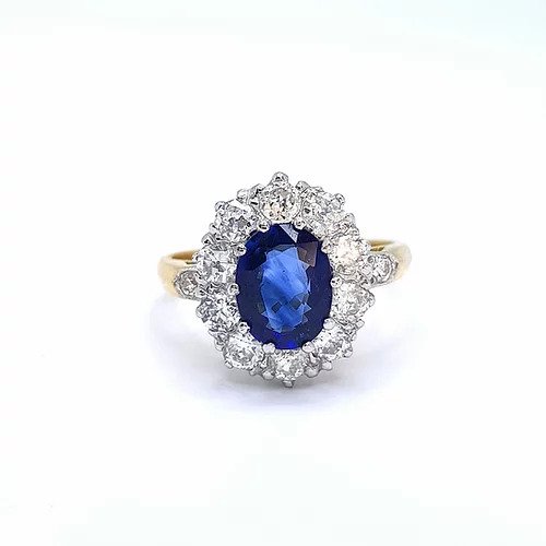 Vintage Sapphire and Diamond Oval Cluster Ring; featuring a 1.50ct oval sapphire surrounded by 1.00ct diamonds, on 18ct yellow gold shank
