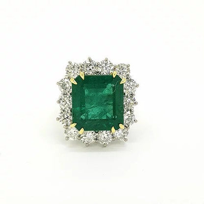 Certified 10.41ct Octagonal Cut Zambian Emerald and Diamond Cluster Ring; central 10.41ct octagonal cut Zambian emerald surrounded by 2.82cts round brilliant-cut diamonds, 18ct white gold. With GCS certificate
