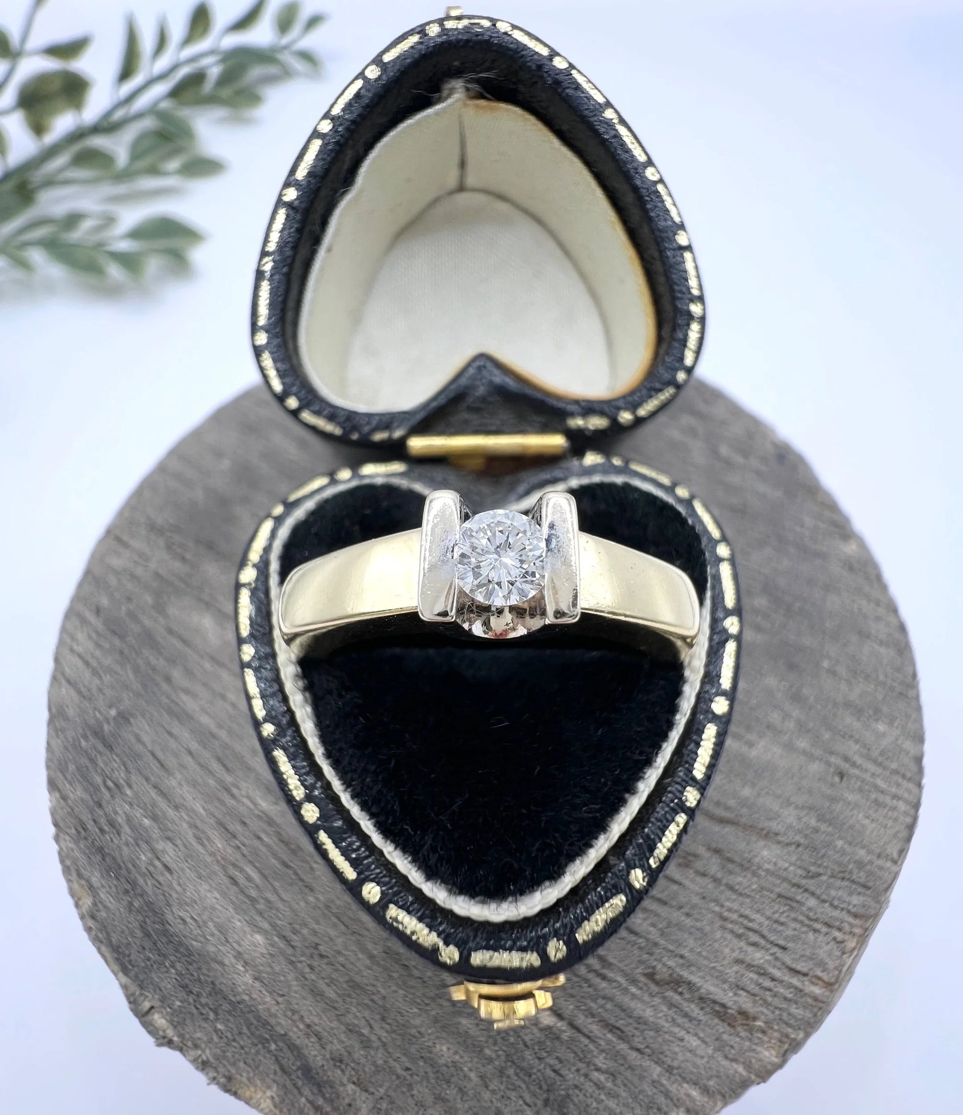 A brilliant cut diamond solitaire ring in yellow gold, in a heart-shaped ring box
