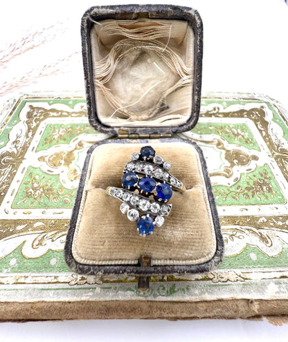 A navette shaped sapphire and diamond ring in yellow gold, in an antique ring box