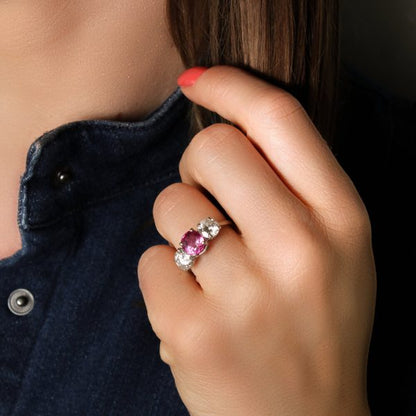 Natural Pink Sapphire and Diamond Three Stone Ring; central 1.50ct natural pink sapphire flanked by 2cts round brilliant-cut diamonds, all claw set in platinum