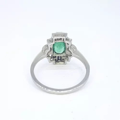 Art Deco Style Emerald and Diamond Plaque Ring; 0.77ct oval emerald surrounded by 0.60cts baguette and round cut diamonds, in 18ct white gold