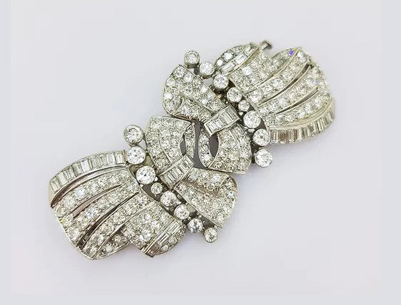 Vintage Diamond Double Clip Bow Brooch; set with baguette and brilliant-cut diamonds, in 18ct white gold. Total diamond weight: approximately 10.00 carats.