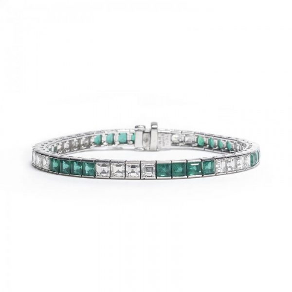 Princess Cut Emerald and Diamond Line Bracelet; channel set with alternating sets of four square-cut emeralds and four step-cut diamonds. Emeralds 8.22 carats, Diamonds 6.69 carats