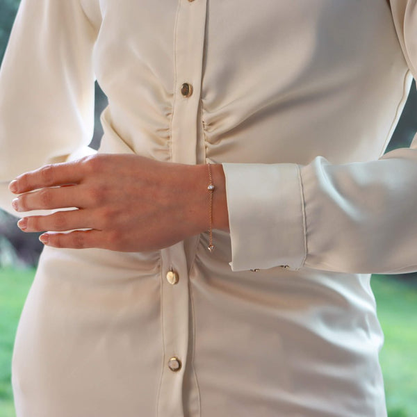 Diamond three stone chain link bracelet in rose gold.