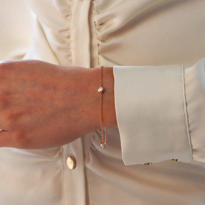 Diamond three stone chain link bracelet in rose gold.