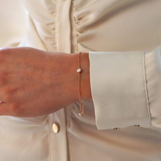 Diamond three stone chain link bracelet in rose gold.