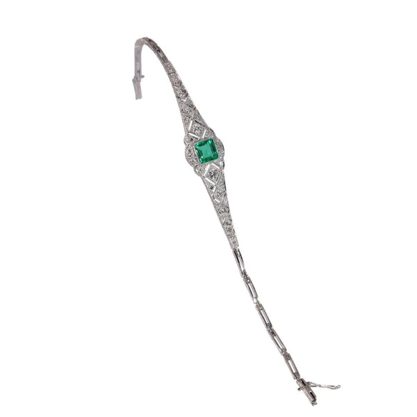 Art Deco Emerald and Diamond Bracelet in Platinum, delicate geometric lines draw the eye to central 1.20ct emerald framed by 0.96cts diamonds, Circa 1920