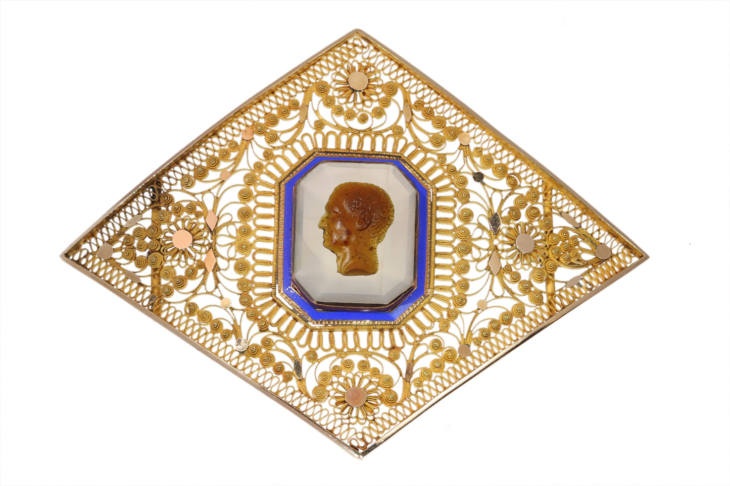 A yellow gold ornate openwork brooch with an agate cameo portrait in the centre, bordered with blue enamel