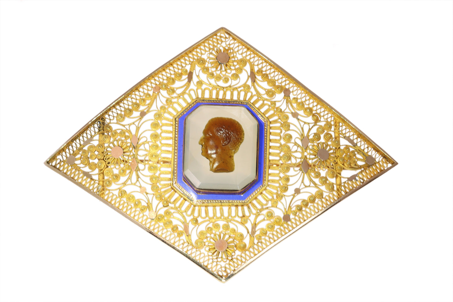 A yellow gold ornate openwork brooch with an agate cameo portrait in the centre, bordered with blue enamel