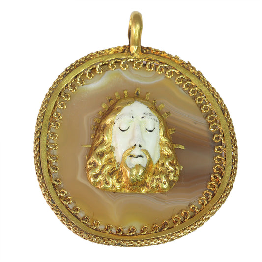 An enamelled face of Christ on a banded agate and yellow gold wirework pendant