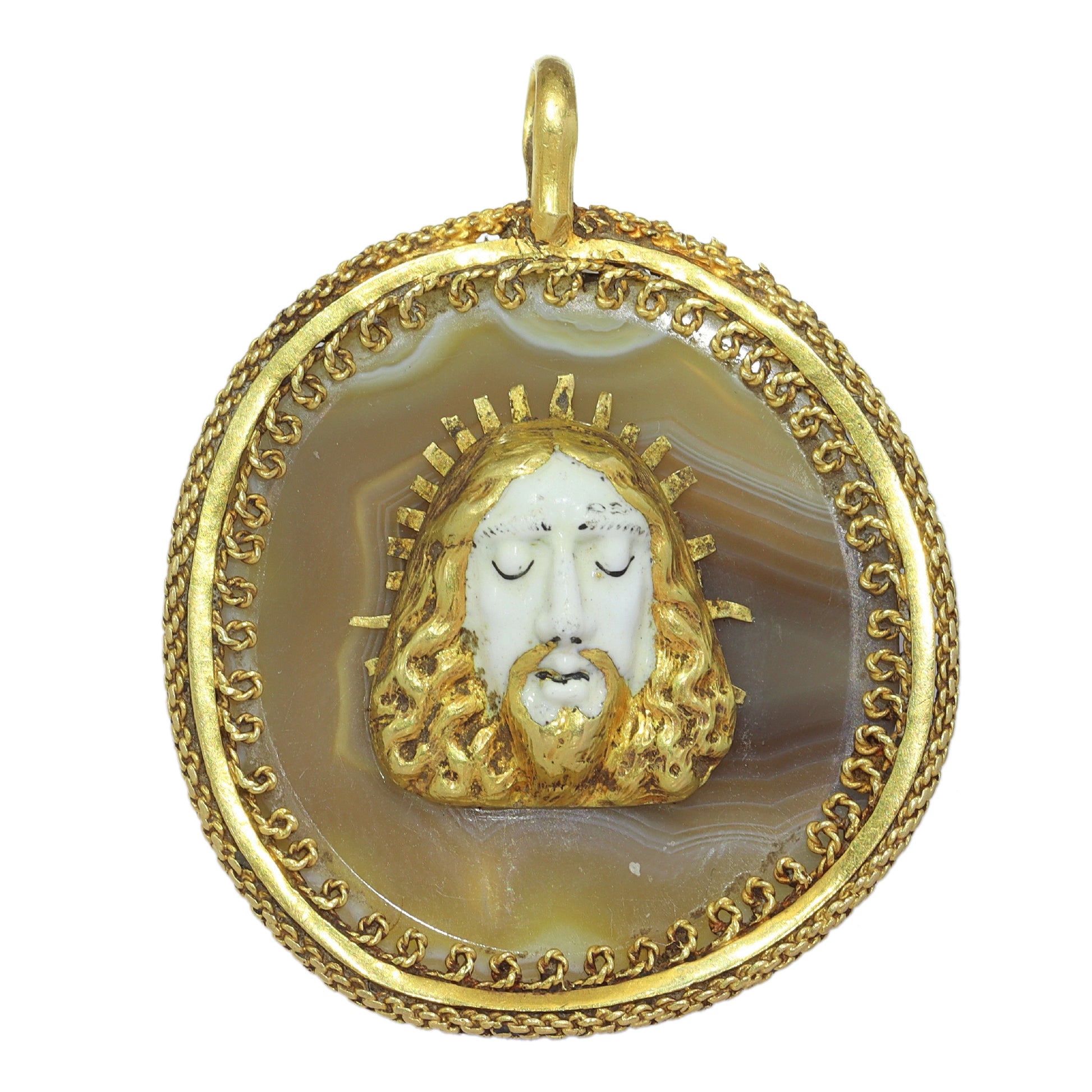 An enamelled face of Christ on a banded agate and yellow gold wirework pendant