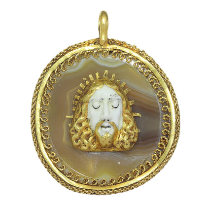 An enamelled face of Christ on a banded agate and yellow gold wirework pendant