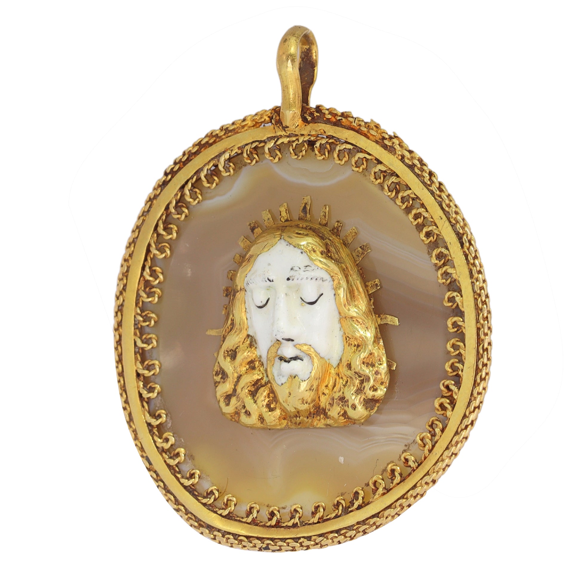 An enamelled face of Christ on a banded agate and yellow gold wirework pendant
